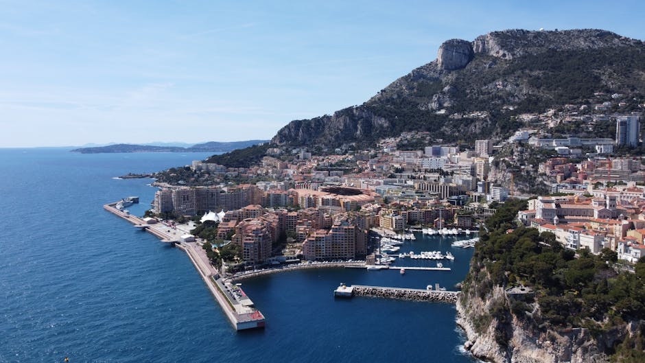Stunning aerial view of Monaco, showcasing the cityscape, harbor, and surrounding mountains