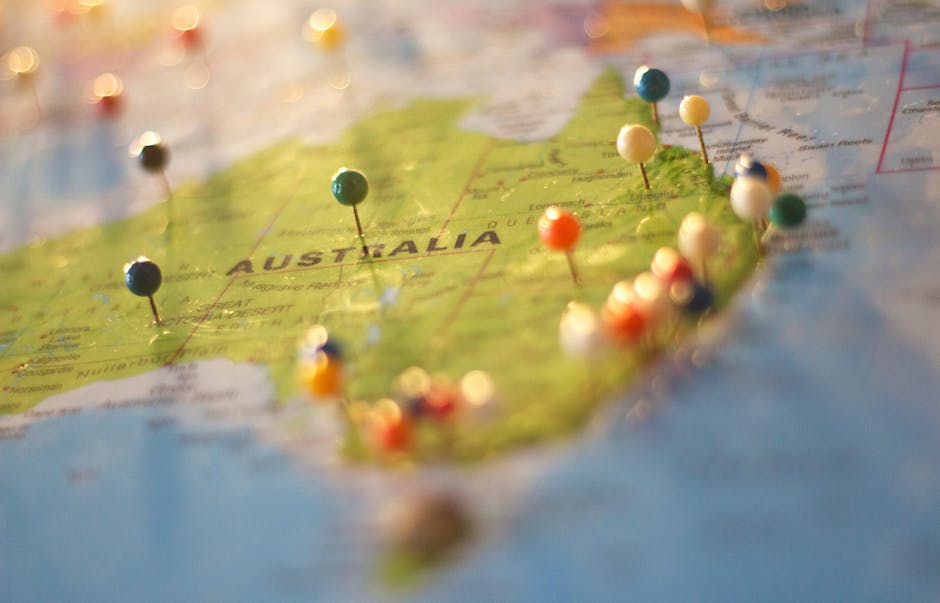 Close-up of a map of Australia with colorful pins marking various cities and destinations