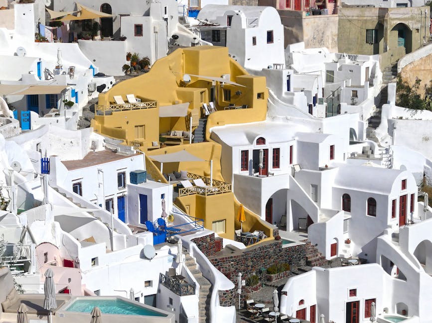 A stunning aerial view of Fira's whitewashed architecture on a sunny day in Santorini, Greece